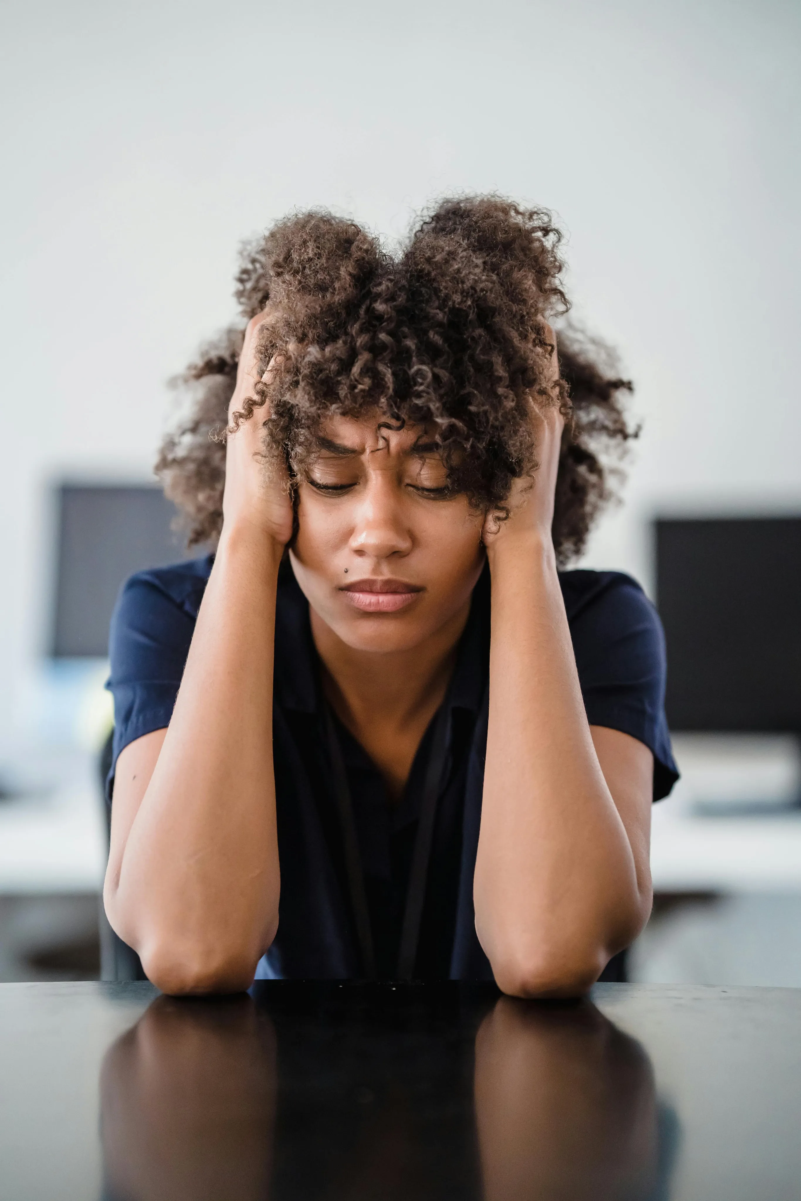 A caregiver at a desk, overwhelmed