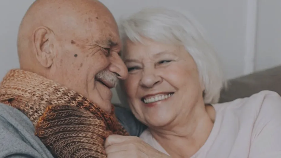 An older couple embracing and smiling