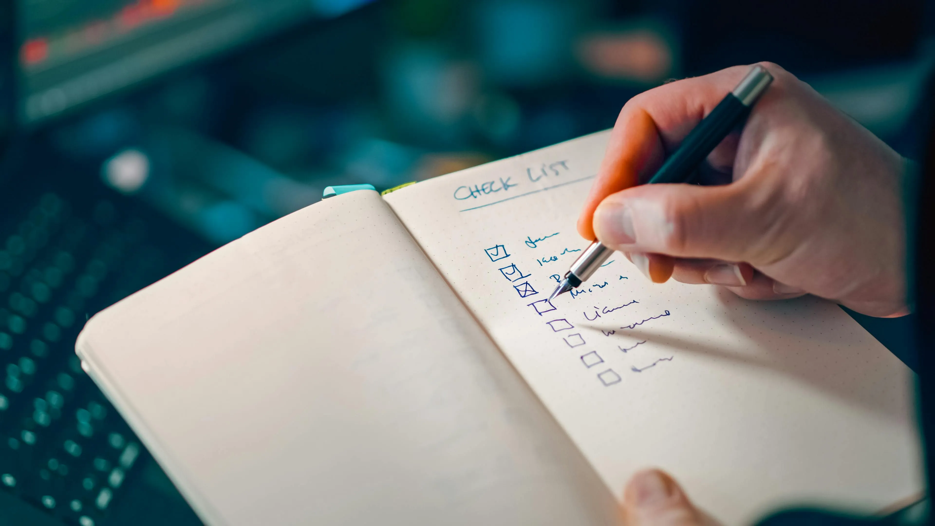 A hand writing in a paper planner
